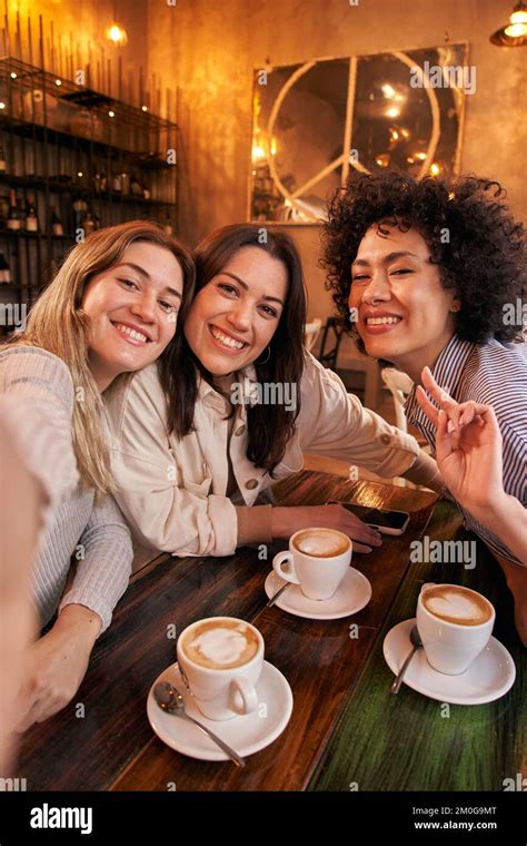 Vertical Photo Of Three Female Friends Take Selfie While Having Fun In