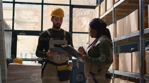 Logistics coordinators in warehouse inputing updated products info on