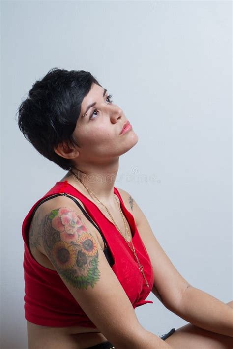 Seated Short Hair Brunette Woman Wearing Red Tank Top Stock Photos