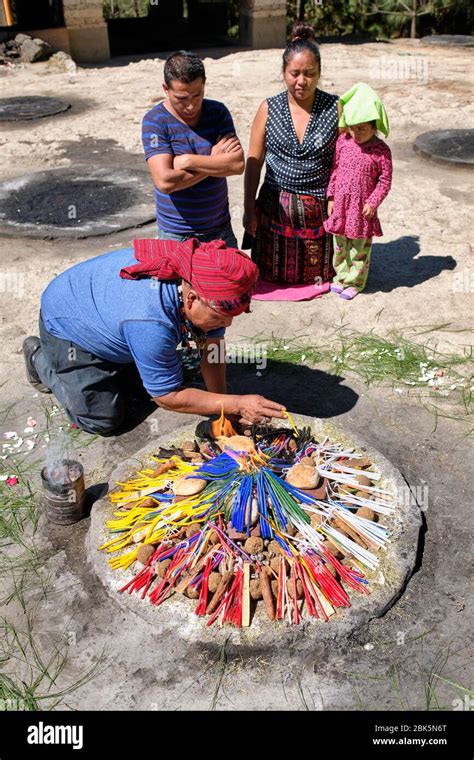 Shaman performing a Mayan healing ceremony for a family on the top of ...