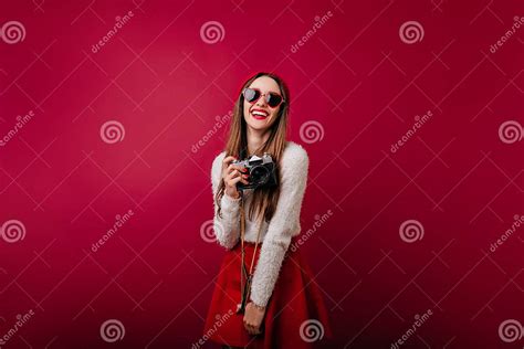 Pleased White Girl In Funny Sunglasses Holding Camera And Laughing