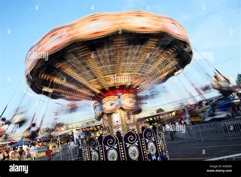 Spinning Carnival Ride Along Midway Blurred Riders Swinging From