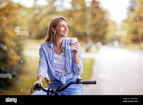 Blonde Woman In Public Park Relaxing On Bike Stock Photo Alamy