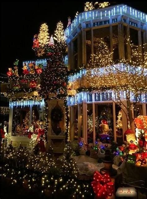 A House Covered In Christmas Lights At Night With Decorations On The