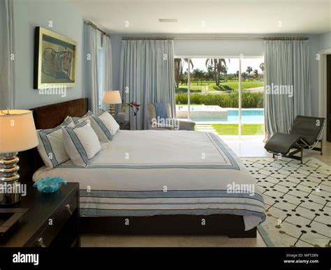 Bedroom with framed artwork above double bed and large rug leading to ...