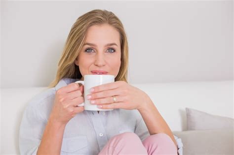 Premium Photo Content Casual Blonde Sitting On Couch Holding Mug