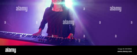 Female Musician Playing Piano In Illuminated Club Stock Photo Alamy