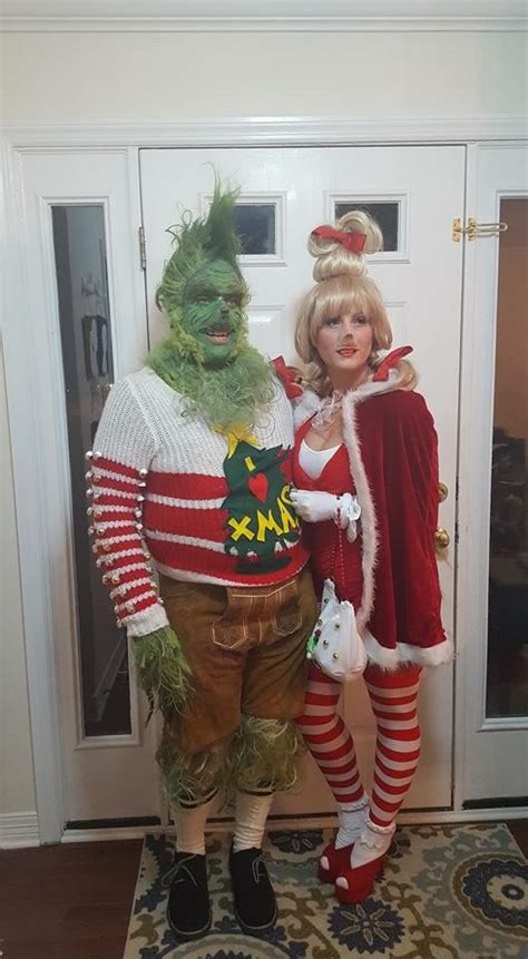 Two People In Costumes Standing Next To Each Other