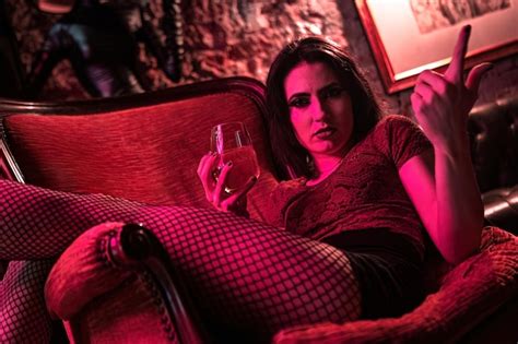 Premium Photo Angry Brunette Girl Holding A Drink And Glaring Intensely On Elegant Vintage