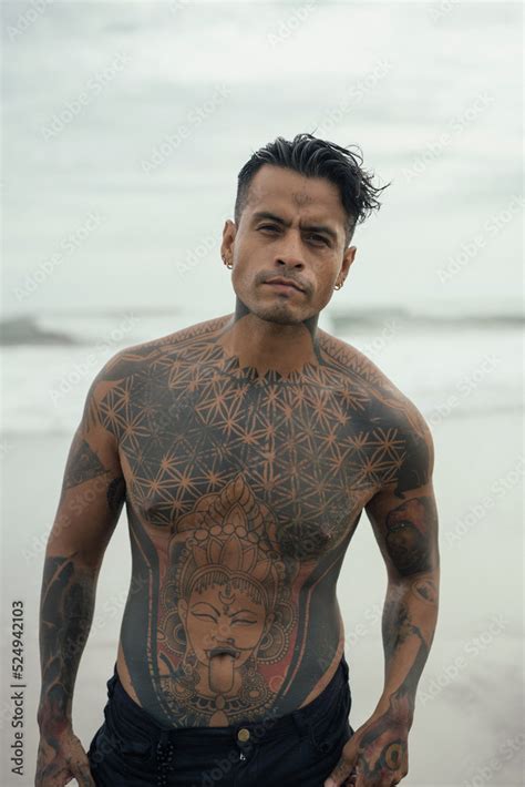 Handsome Tanned Tattooed Sexy Man With A Naked Torso In A Flying Poreo