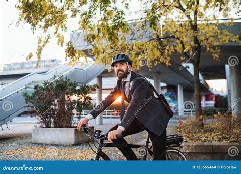 Hipster Businessman Commuter With Electric Bicycle Traveling Home From