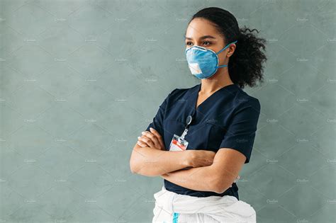 Female nurse wearing a medical mask | Health Stock Photos ~ Creative Market