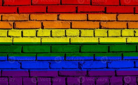 Flag Of The LGBT Community On The Background Of A Stone Wall Rainbow Symbol Of Gay Culture