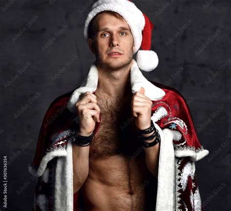 Sexy Man Wear Red Santa Claus Costume For Christmas For Christmas Party With Naked Torso And