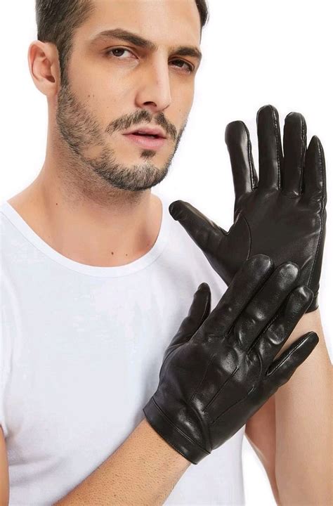 A Man In White Shirt And Black Gloves Holding His Hand Up To The Camera