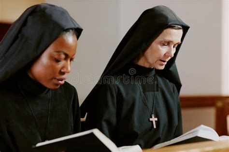 Two Catholic Nuns Praying stock photo. Image of read - 324505164