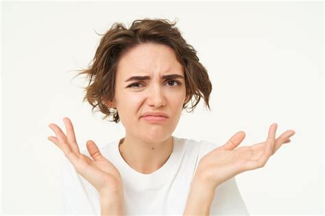 Free Photo Close Up Of Shocked Brunette Woman Shrugging And Looking Disappointed Posing Over