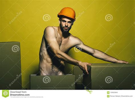 Guy With Naked Torso Moves Boxes Macho With Serious Face Wears Helmet Stock Image Image Of