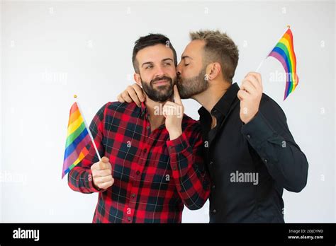 Happy Gay Couple Holding The Homosexual Flag Over White Background Stock Photo Alamy