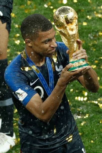 France S Forward Kylian Mbappe Holds The Trophy As He Celebrates During