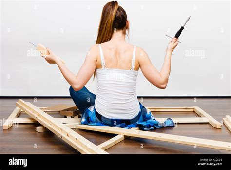 Woman Assembling Wooden Furniture Using Screwdriver Diy Enthusiast