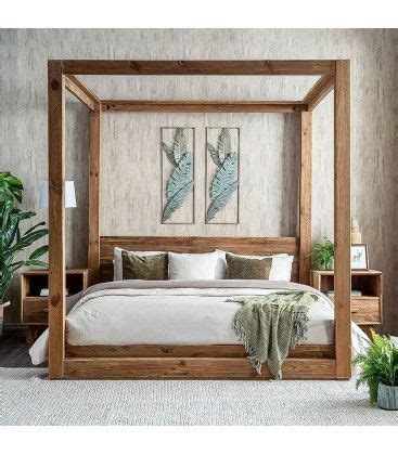 A Bedroom With A Four Poster Bed And Two Planters On The Side Of The Bed