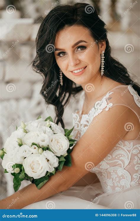 Beautiful Brunette Bride Embracing In To The Bedroom Stock Photo