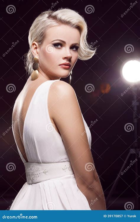 A Gorgeous Blonde Girl In A Sexy Red Dress With Deep Slits On The Hips Royalty Free Stock Photo