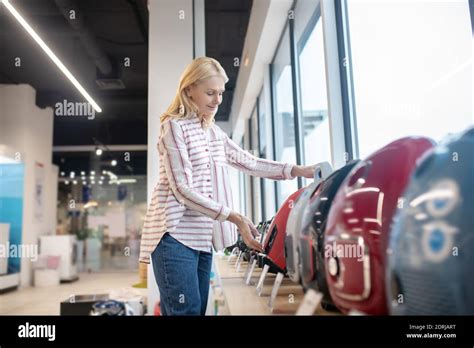Blonde Customer Choosing A Vacuum Cleaner In A Showroom Stock Photo Alamy