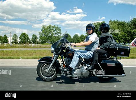 Senior Couple Riding Harley Davidson Motorcycle On Interstate Highway