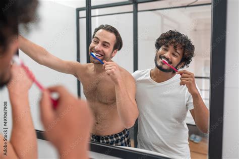 Happy Gay Couple Brushing Their Teeth In The Bathroom Stock Photo Adobe Stock
