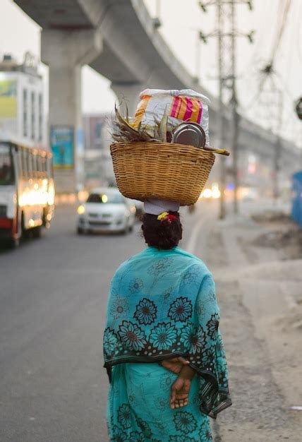 Premium Photo Rear View Of Woman Carrying Basket On Head