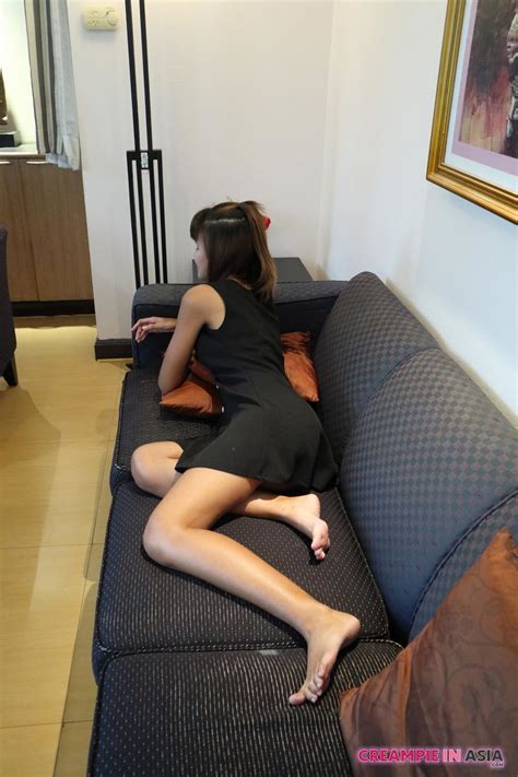 Petite Asian Babe Strips Naked And Shows Her Trimmed Bush On The Couch CoedCherry