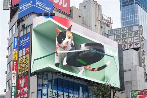 Tokyos Giant 3d Calico Cat Now Has A Roomba As A Friend