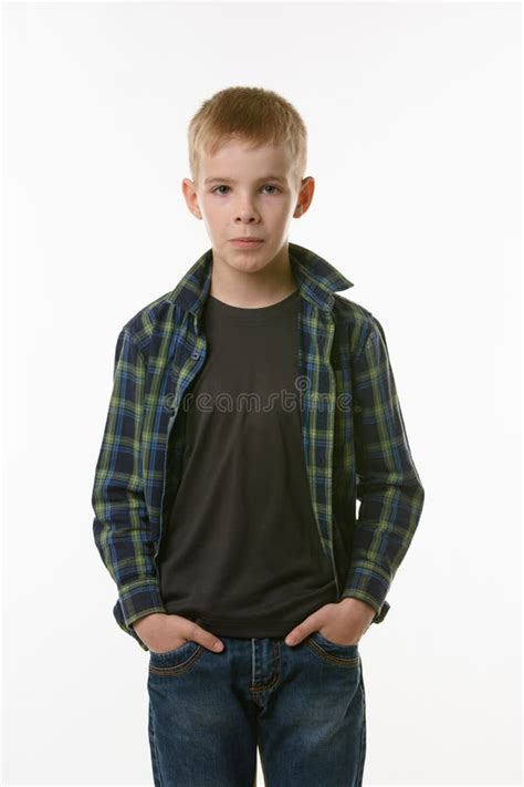 Portrait Of A Boy Of Ten Years In A Plaid Shirt And Jeans Stock Photo