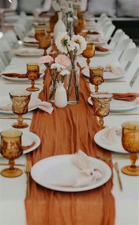 The Table Is Set With White And Gold Plates