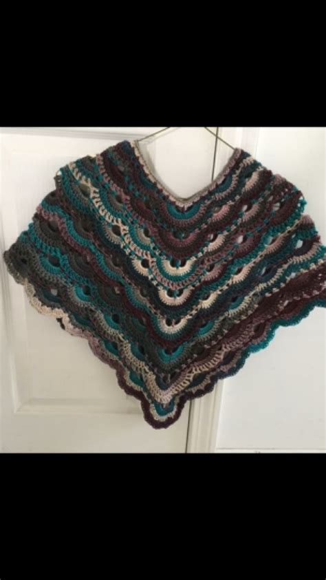 A Crocheted Shawl Hanging On A Door