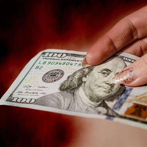 Premium Photo Cropped Hand Holding Paper Currency