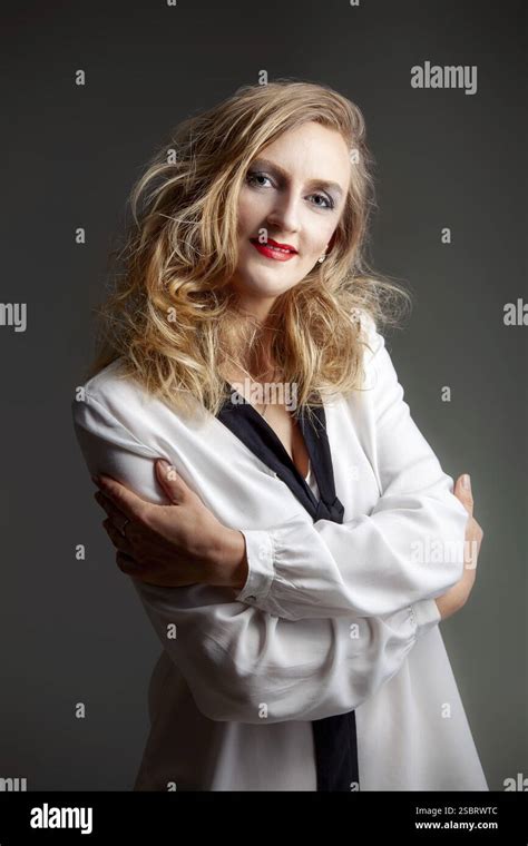 Portrait Of A Woman With Perfect Blonde Hair And Make Up Over Grey Background Stock Photo Alamy