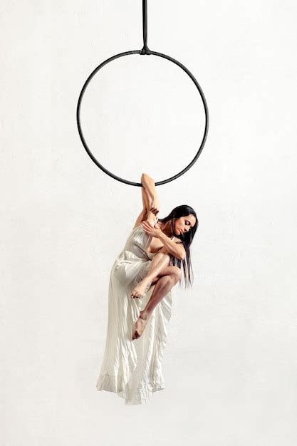 Premium Photo Barefoot Brunette Hanging On Aerial Hoop