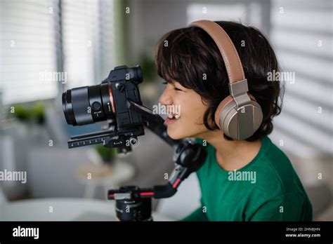 Happy Multiracial Boy Cameraman Amateur With Headphones At Home Stock Photo Alamy