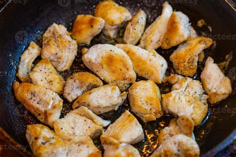 fried chicken in a pan with ground black pepper 12633250 Stock Photo at Vecteezy