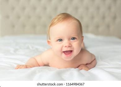 Стоковая фотография Naked Lovely Little Baby Laying On Shutterstock