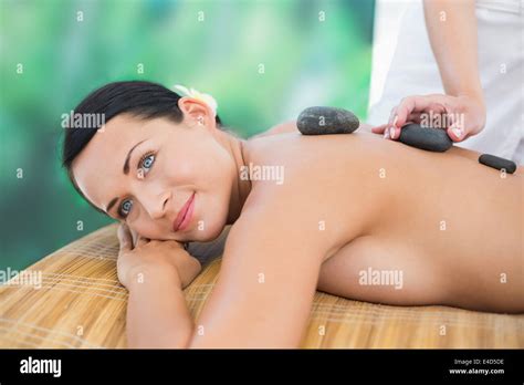 Beautiful Brunette Enjoying A Hot Stone Massage Stock Photo Alamy