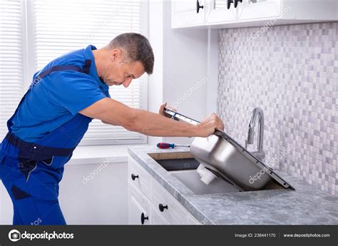 Photo Mature Male Workman Fixing Kitchen Sink Stock Photo By