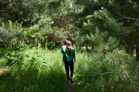 Premium Photo Rear View Of Women Walking In Forest