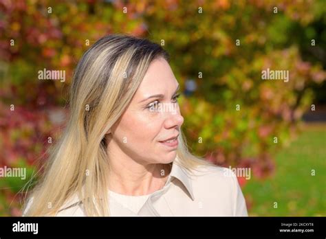 Attractive Middle Aged Blonde Woman Daydreaming Looking To The Side In