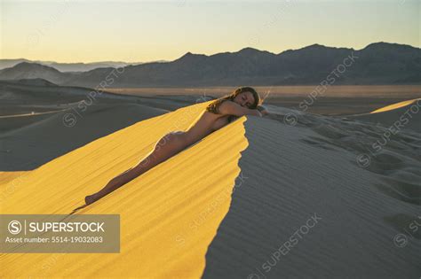 Naked Female Laying On A Sand Dune SuperStock