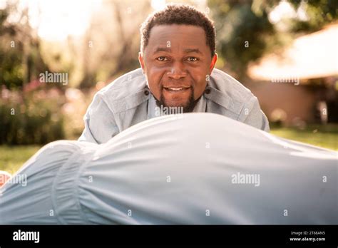 A Pregnant Latina Woman And African Man Couple In A Lush Green Sunlit Park Stock Photo Alamy