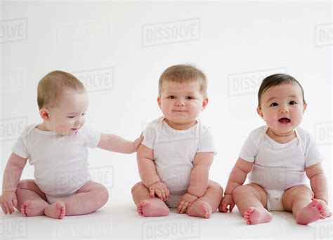 babies sitting  floor stock photo dissolve